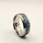Silver ring with blue pattern on a white background