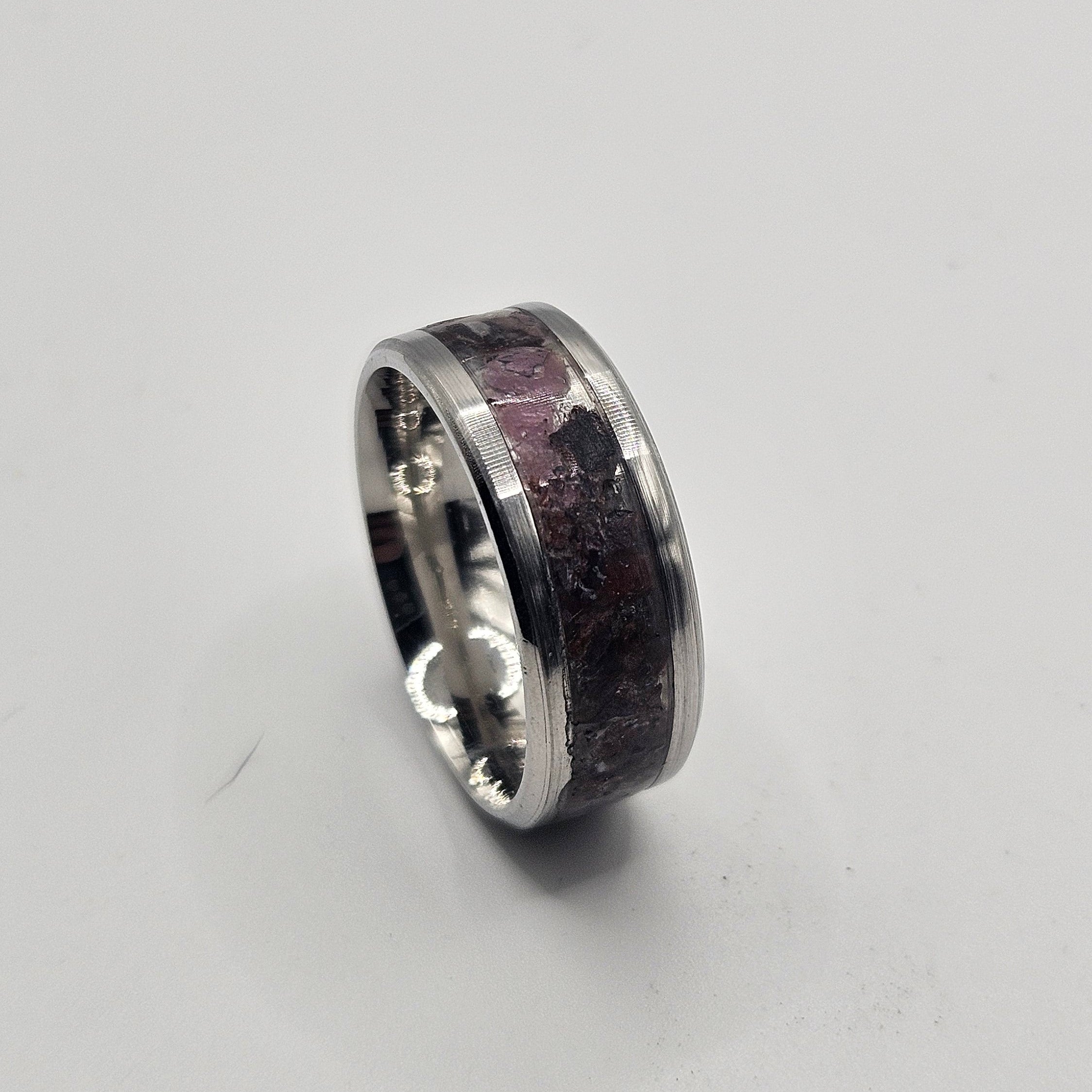 Silver ring on a light gray background