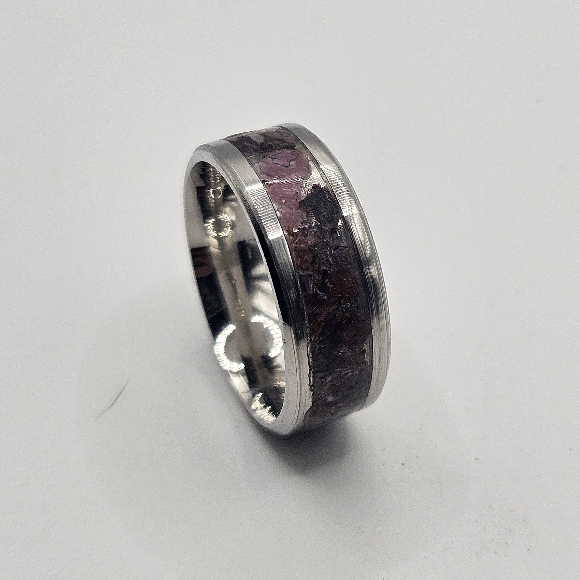 Silver ring on a light gray background